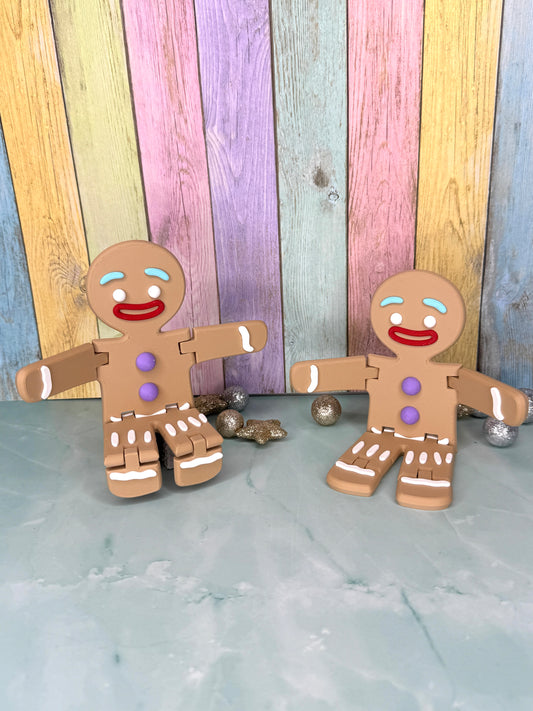 zwei 3D-gedruckter Lebkuchenmann mit frei beweglichen Armen und Beinen sitzend