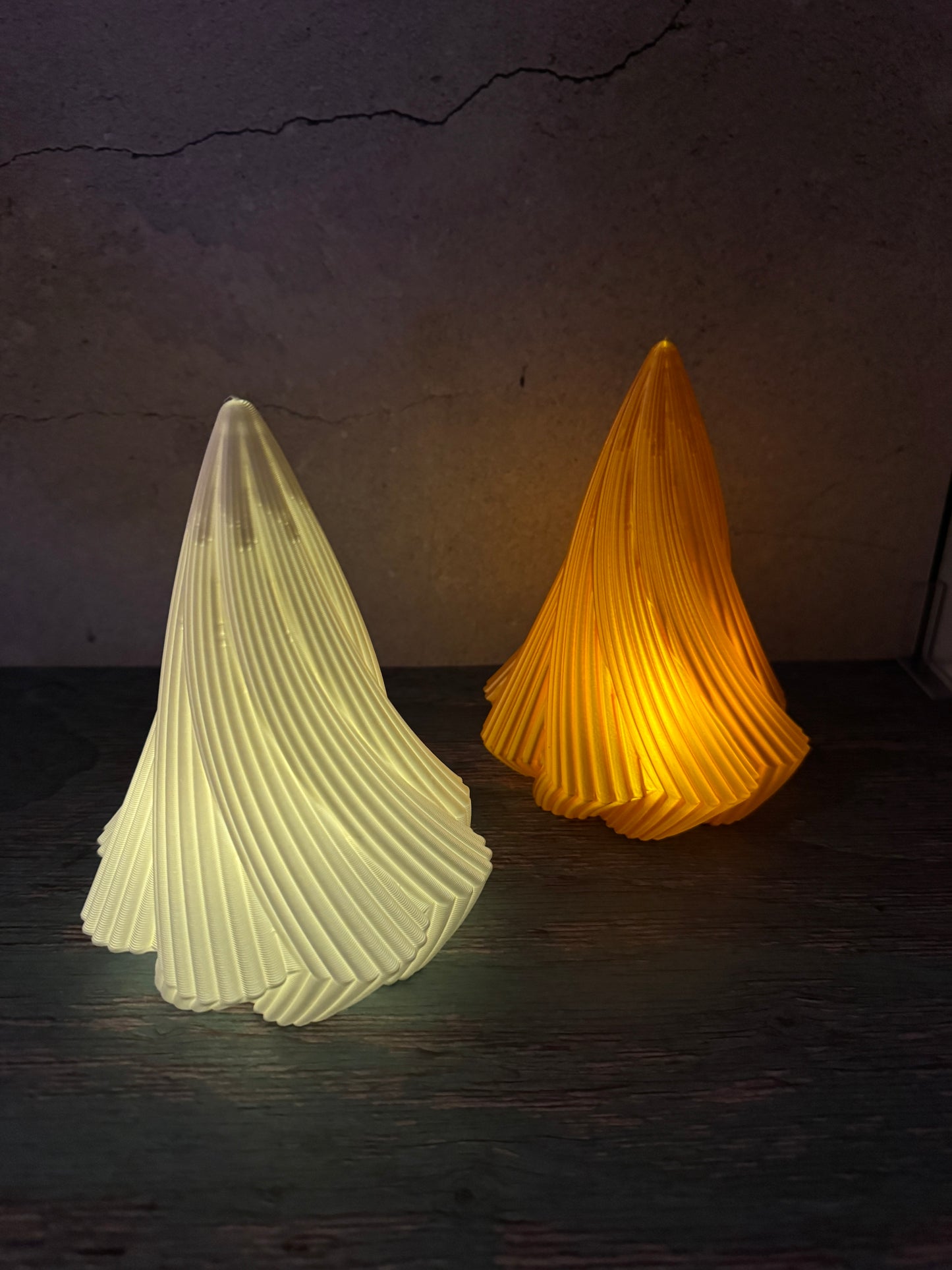 Gedrehte 3D-gedruckte Weihnachtsbäume in Weiß und Gold beleuchtet mit LED-Teelichter