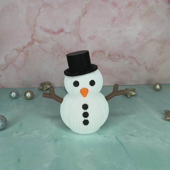 Kleiner Schneemann im gestrickten Design mit eingesetztem LED-Teelicht, stimmungsvolle Beleuchtung